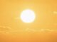 Bright sun in a clear orange sky.