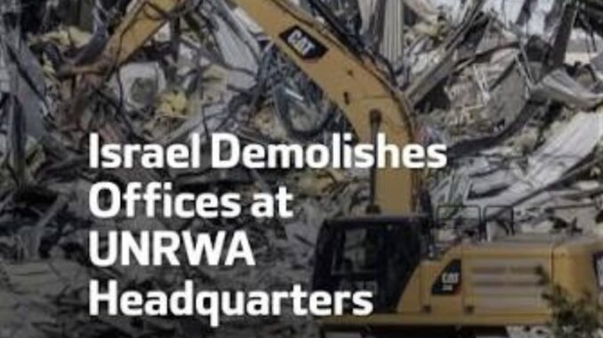 Excavator demolishing UNRWA headquarters building rubble. Excavator demolishing UNRWA headquarters building rubble.