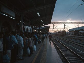 Crowded train platform at sunset.