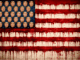 American flag with faces and dripping paint.