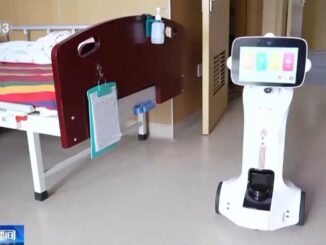 Hospital room with robot near bed.