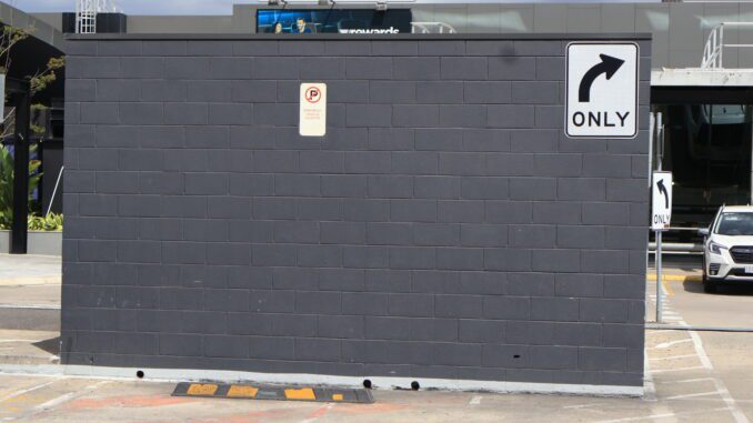 Brick wall with right turn sign. Brick wall with right turn sign.