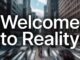 Blurry city street with "Welcome to Reality".