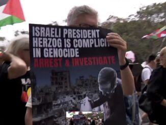 Protester holding sign at a rally.