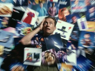 Man overwhelmed by numerous colorful images.