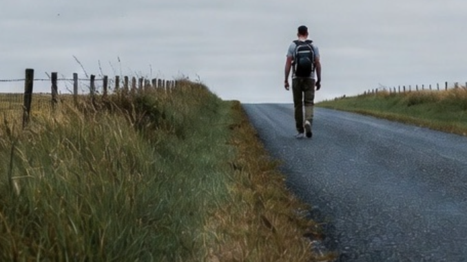 Man walking alone on a rural road. Man walking alone on a rural road.