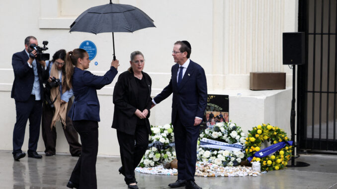 People paying respects at a memorial ceremony.