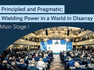 Conference audience in a large auditorium setting.