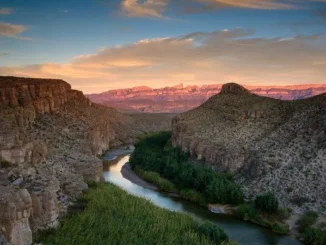 Canyon landscape with river at sunset.