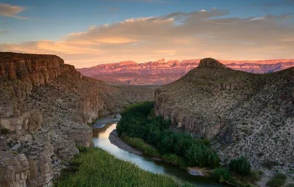 Canyon landscape with river at sunset.