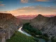 Canyon landscape with river at sunset.