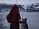 Woman and child walking through refugee camp.