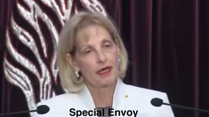 Woman speaking at podium, "Special Envoy" text.