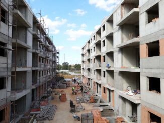 Construction site with partially built apartment buildings.