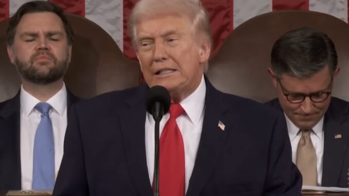Man speaking at podium with audience behind. Man speaking at podium with audience behind.