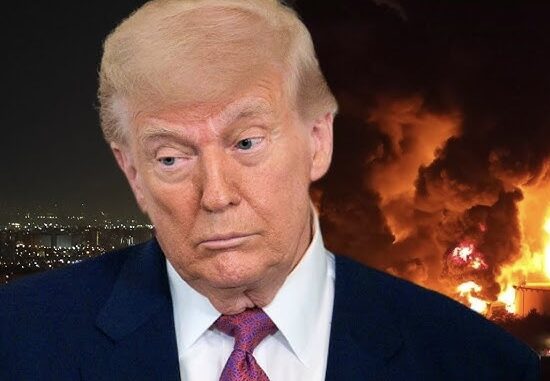 Concerned man with blazing fire behind him
