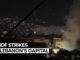 Nighttime cityscape with smoke and text overlay.