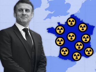 Man beside France map with nuclear symbols.