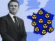 Man beside France map with nuclear symbols.