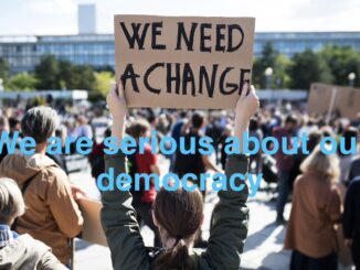 Protesters holding signs for democratic change.