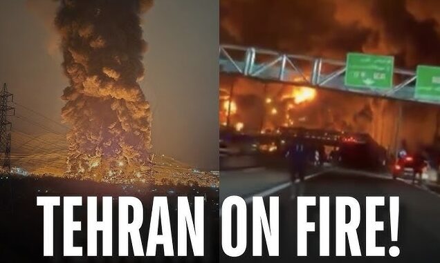 Tehran engulfed in large fire, night scene.