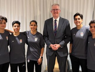 Group photo with five athletes and man.