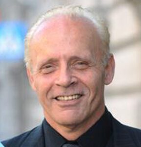 Smiling man with a blurred background.