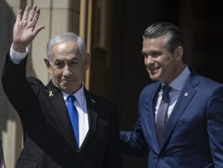 Two men in suits, one waving hand.