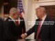 Two men shaking hands, discussing strategy.