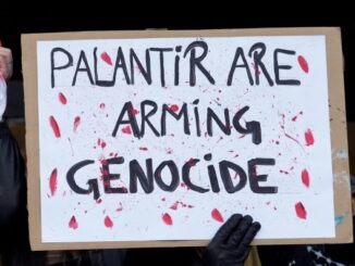 Protest sign reading "Palantir are arming genocide.