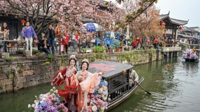 Women in traditional attire on flower boat. Women in traditional attire on flower boat.