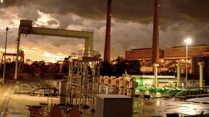 Industrial facility at sunset with smokestacks. Industrial facility at sunset with smokestacks.