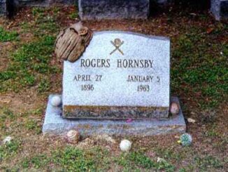 Baseball-themed gravestone with dates and name.