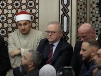 Group of men sitting in a mosque.
