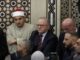 Group of men sitting in a mosque.