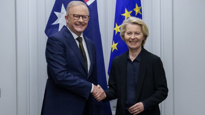 Two people shaking hands, flags behind them. Two people shaking hands, flags behind them.
