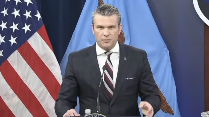 Official delivering statement at podium with flags