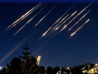 Lights streaking across night sky over city.