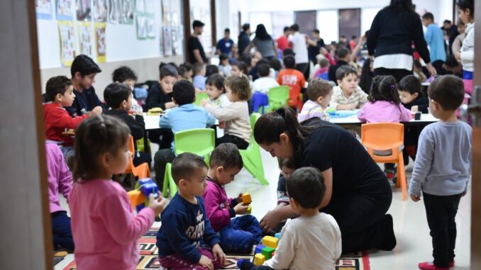 Children playing and learning in a classroom.