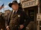 Sheriff in western town with American flag