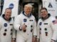 Three people in NASA spacesuits giving thumbs-up