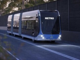 Futuristic metro bus on a quiet road.