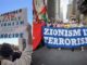 Protesters holding anti-Zionism signs and banners.