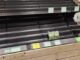 Nearly empty supermarket produce shelf with two packages