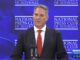 Man speaking at National Press Club podium