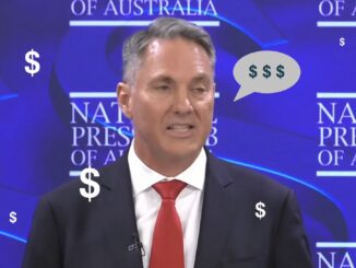 Man speaking at press club with dollar symbols