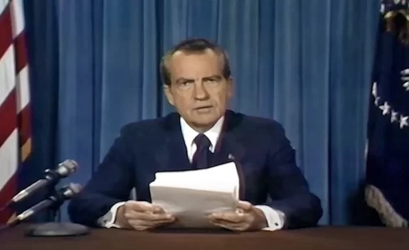 Man reading papers at podium with microphones Man reading papers at podium with microphones