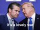 Two men whispering at political rally