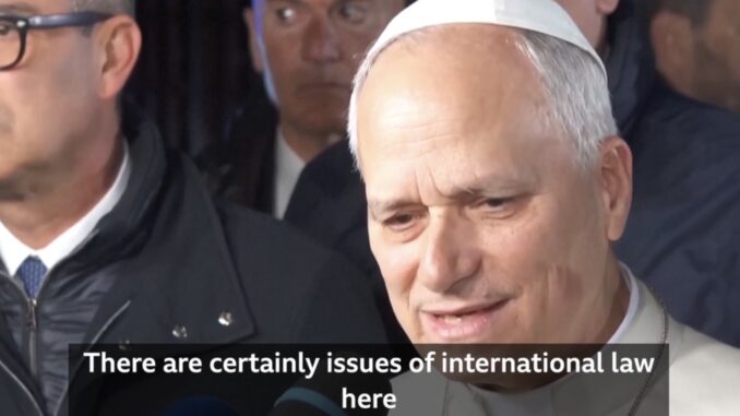 Man in white skullcap speaking to reporters Man in white skullcap speaking to reporters