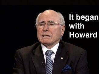 Older man in suit speaking against black background